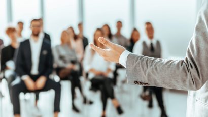 background image of a speaker standing in front of listeners in a conference room background image of a speaker standing in front of listeners in a conference room. photo with copy space